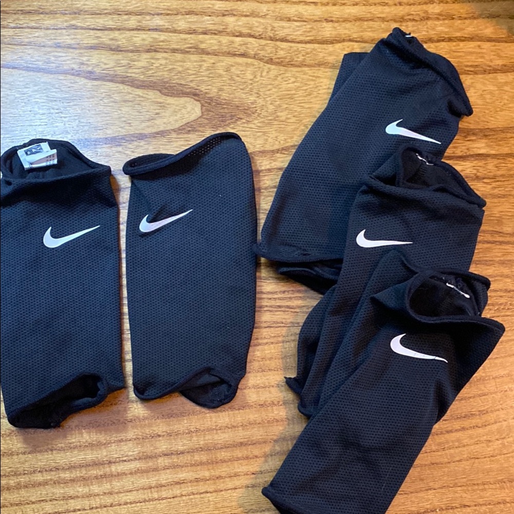 Nike Black large shin guard sleeves. 4 pairs. Lightly worn.